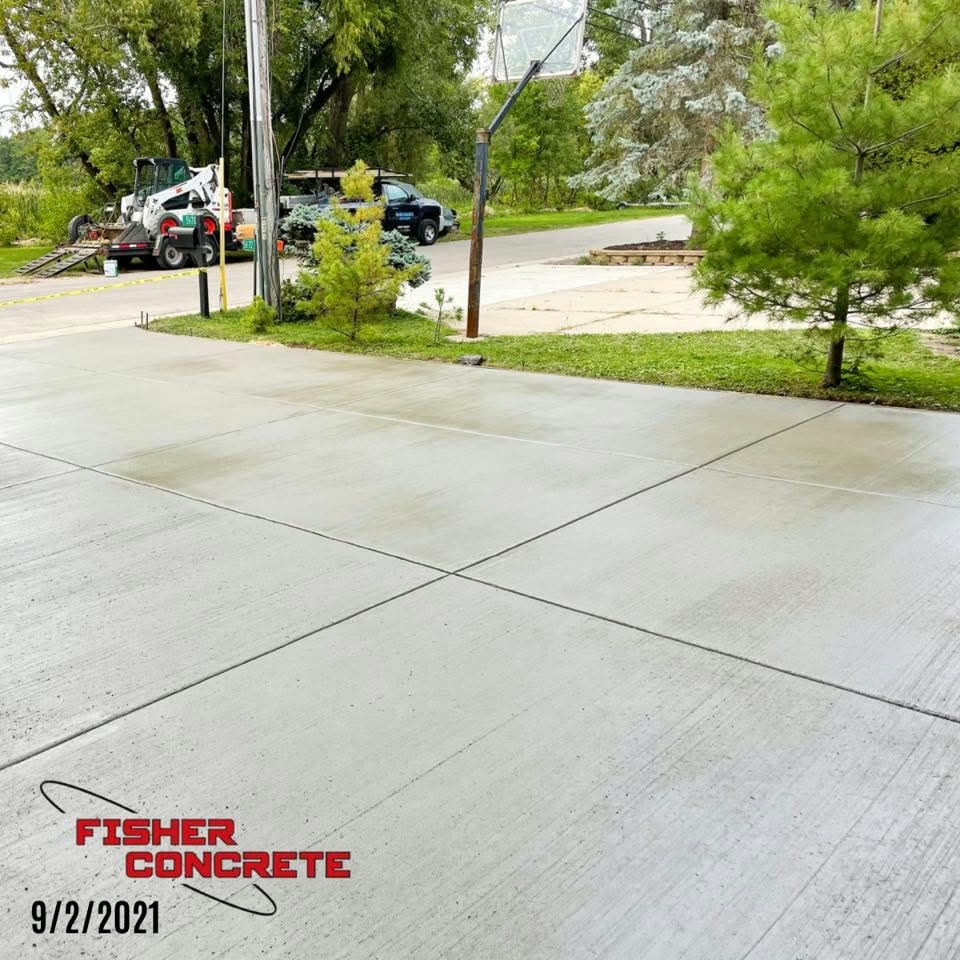 New concrete driveway with basketball hoop and clean control joints