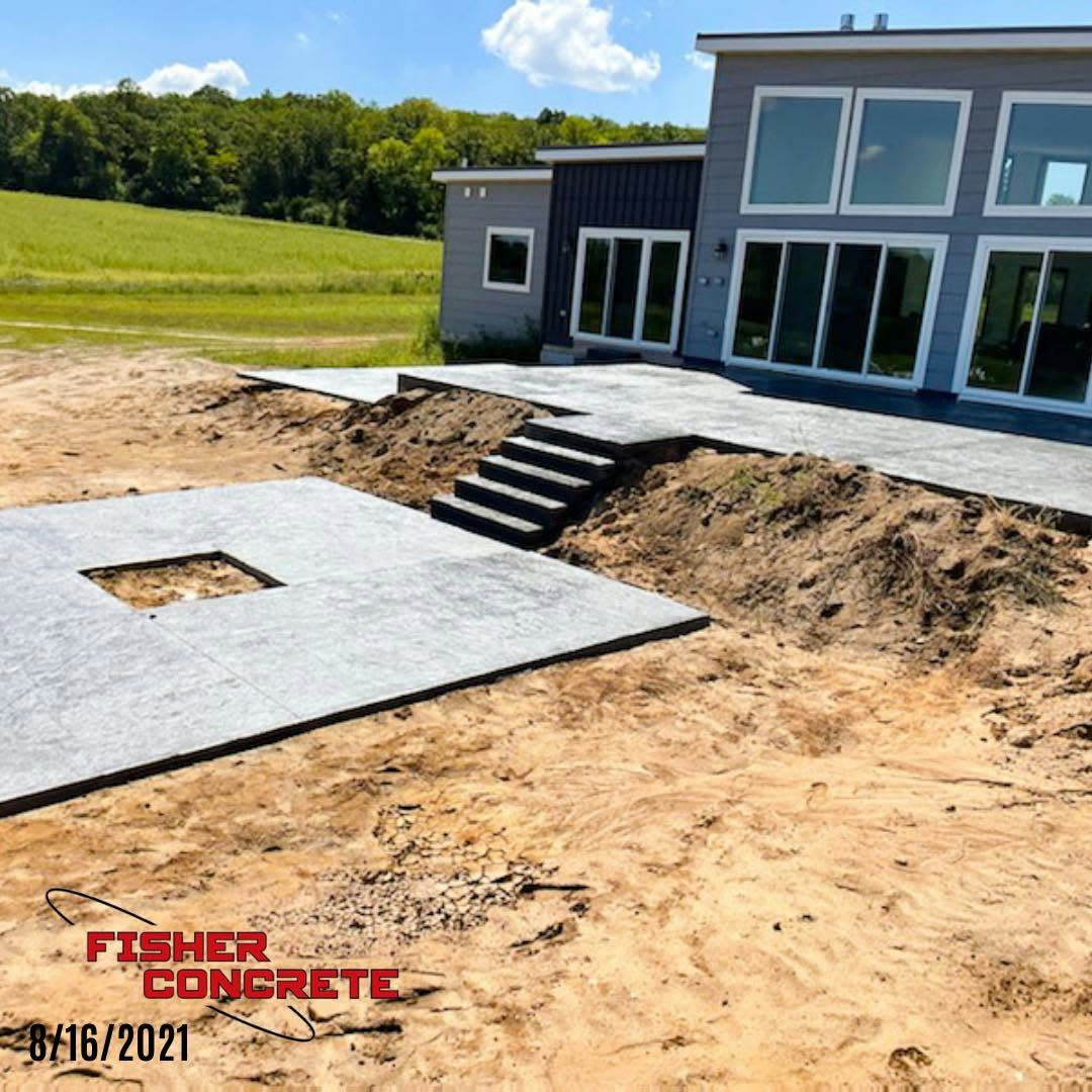 Multi-level concrete patio and steps at a modern home