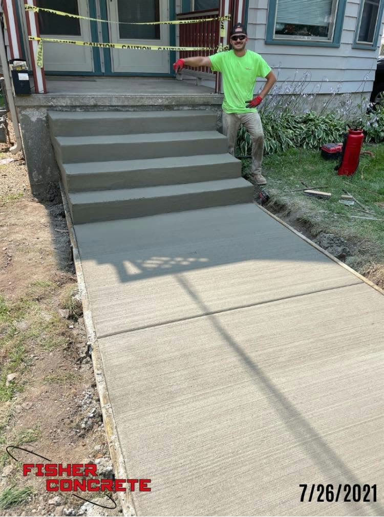 New concrete front steps and sidewalk with crew member