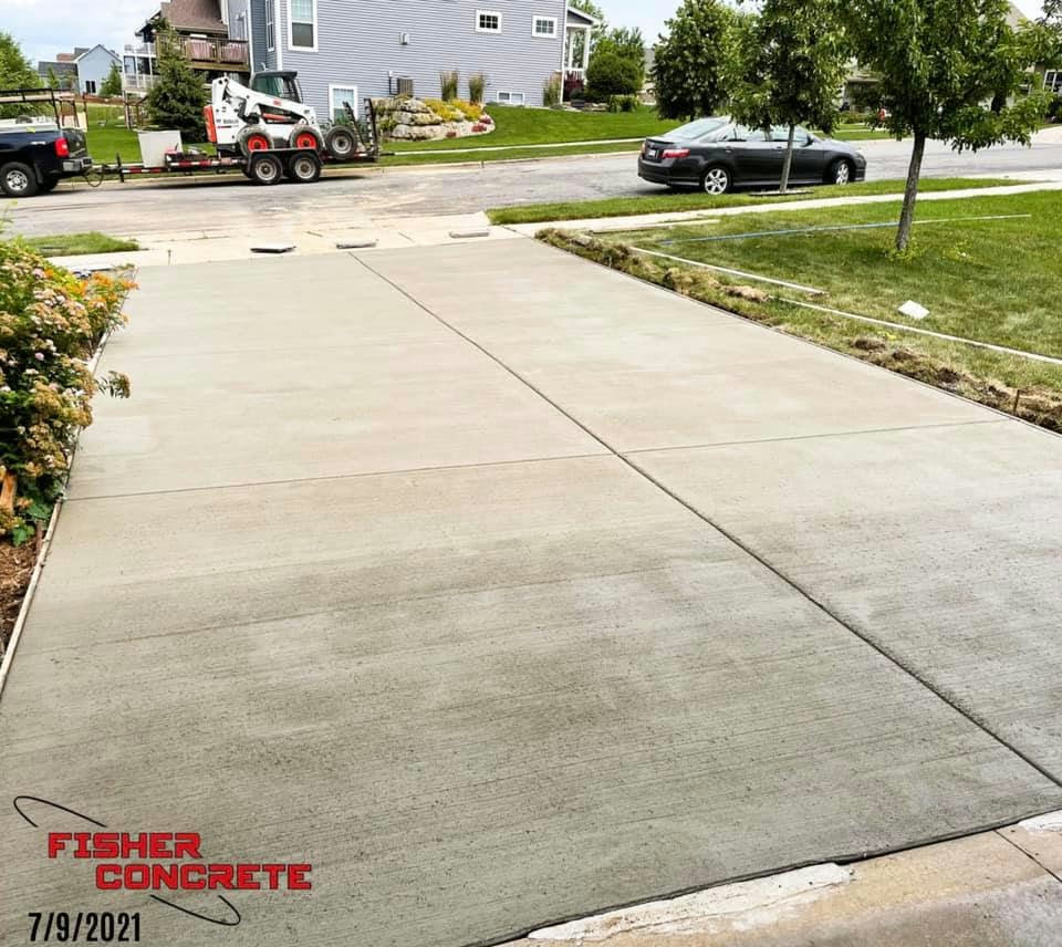 Freshly poured residential driveway to the street