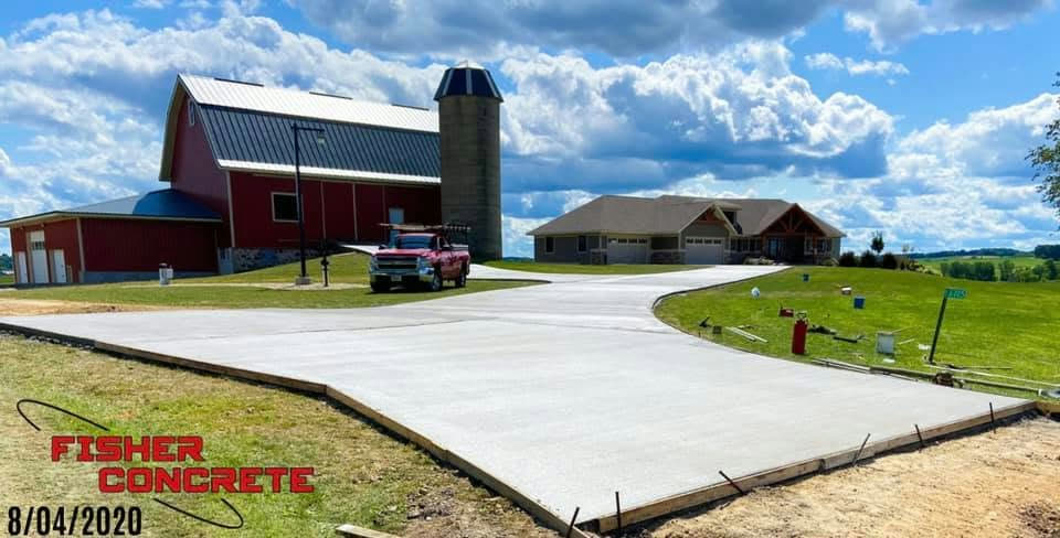 Rural farm driveway poured between barn and ranch home
