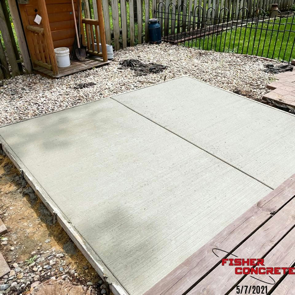 Shed floor slab poured in a fenced backyard