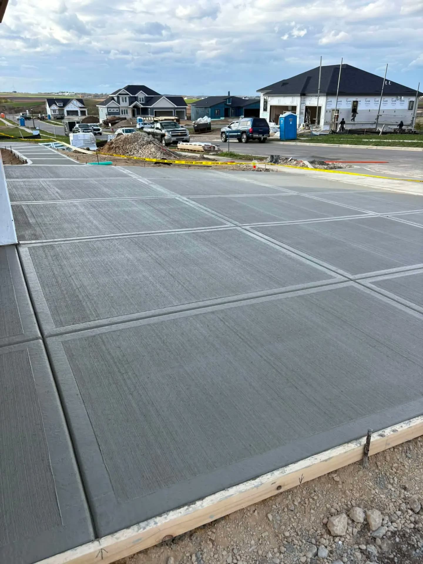 Broom-finished driveway with decorative border bands in a new subdivision