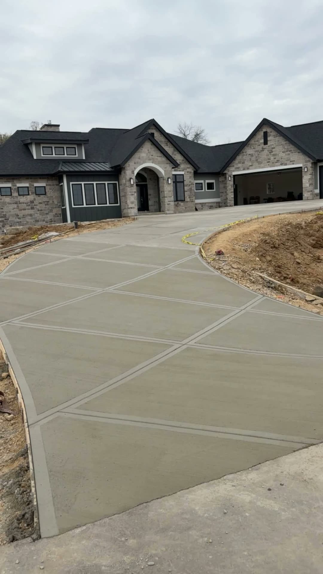 Curved residential concrete driveway with banded borders
